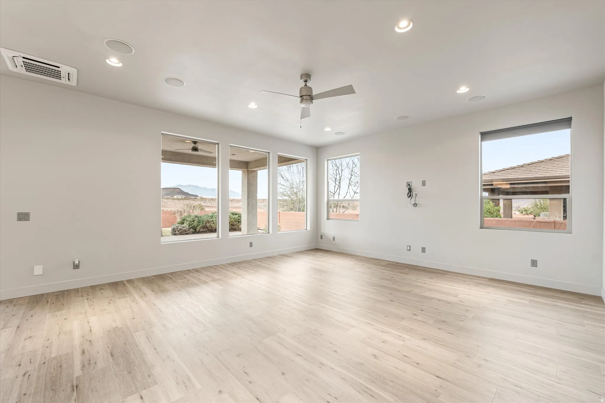Spare room featuring light wood finished floors, cooling unit, ceiling fan, recessed lighting, and a mountain view