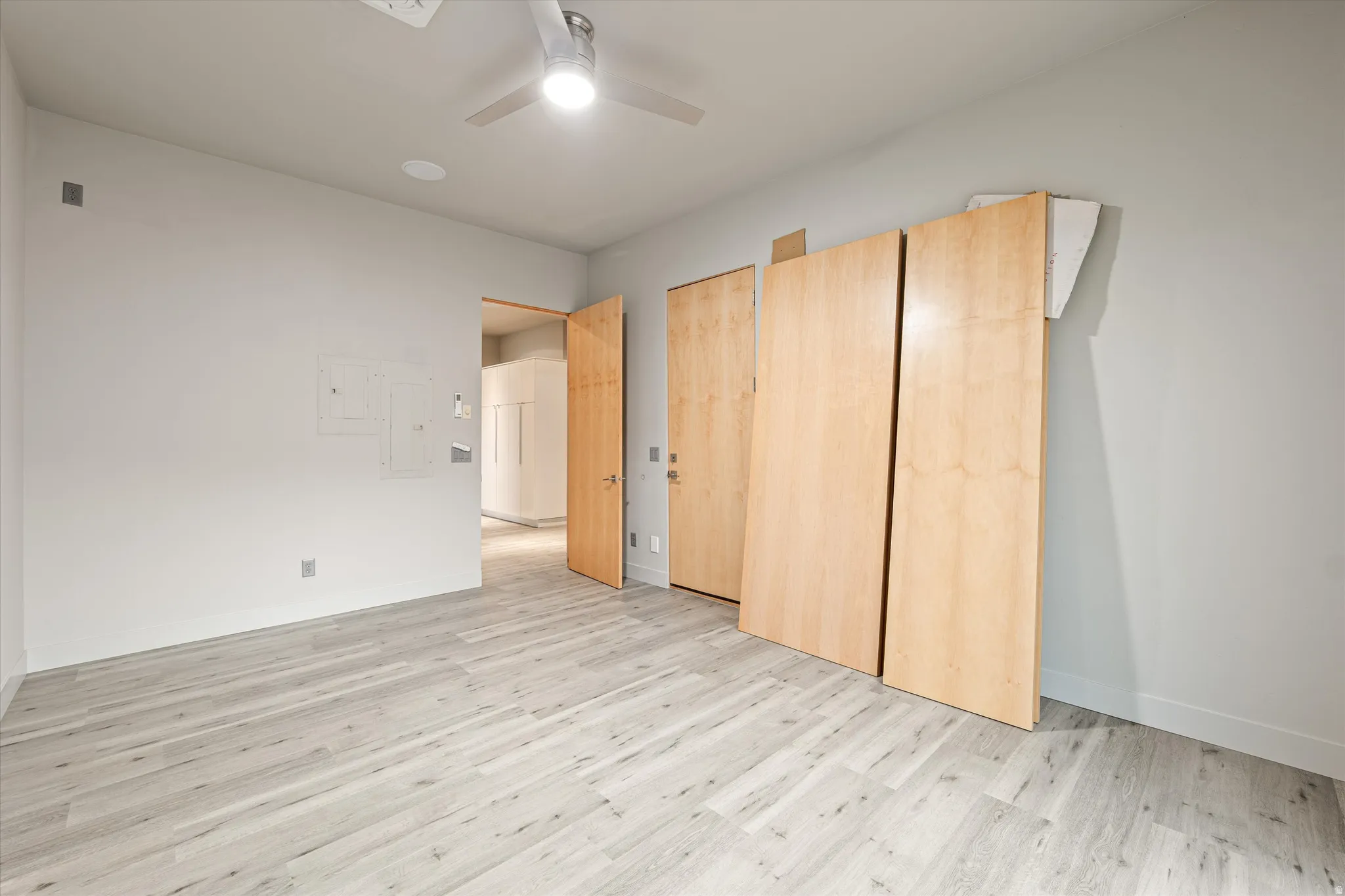 Unfurnished bedroom with light wood finished floors and ceiling fan
