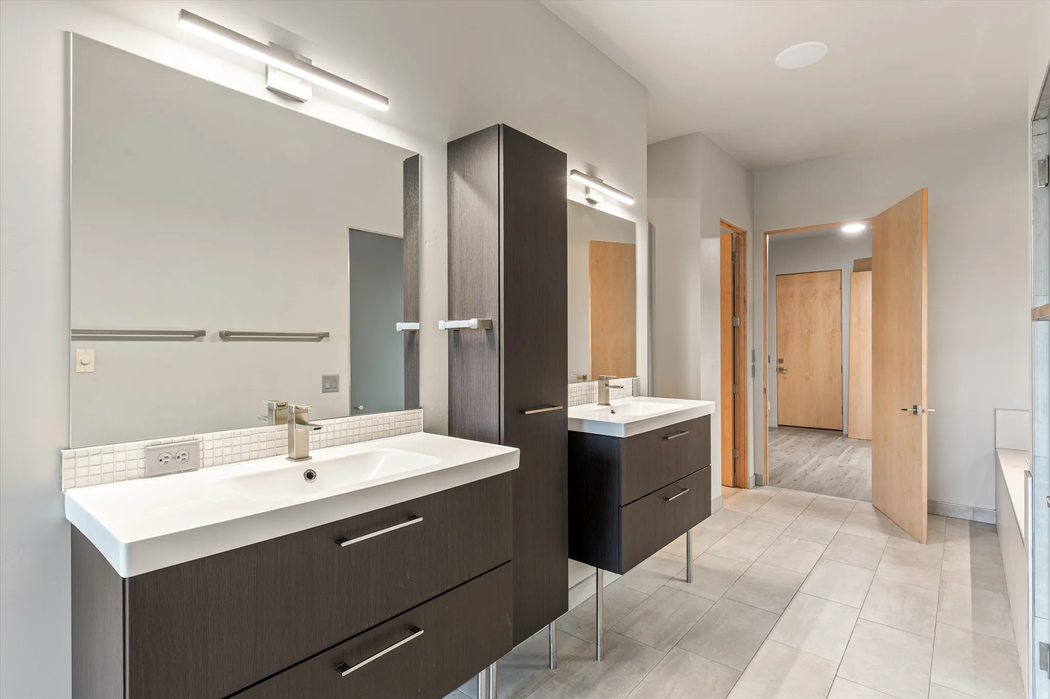 Full bathroom featuring two vanities