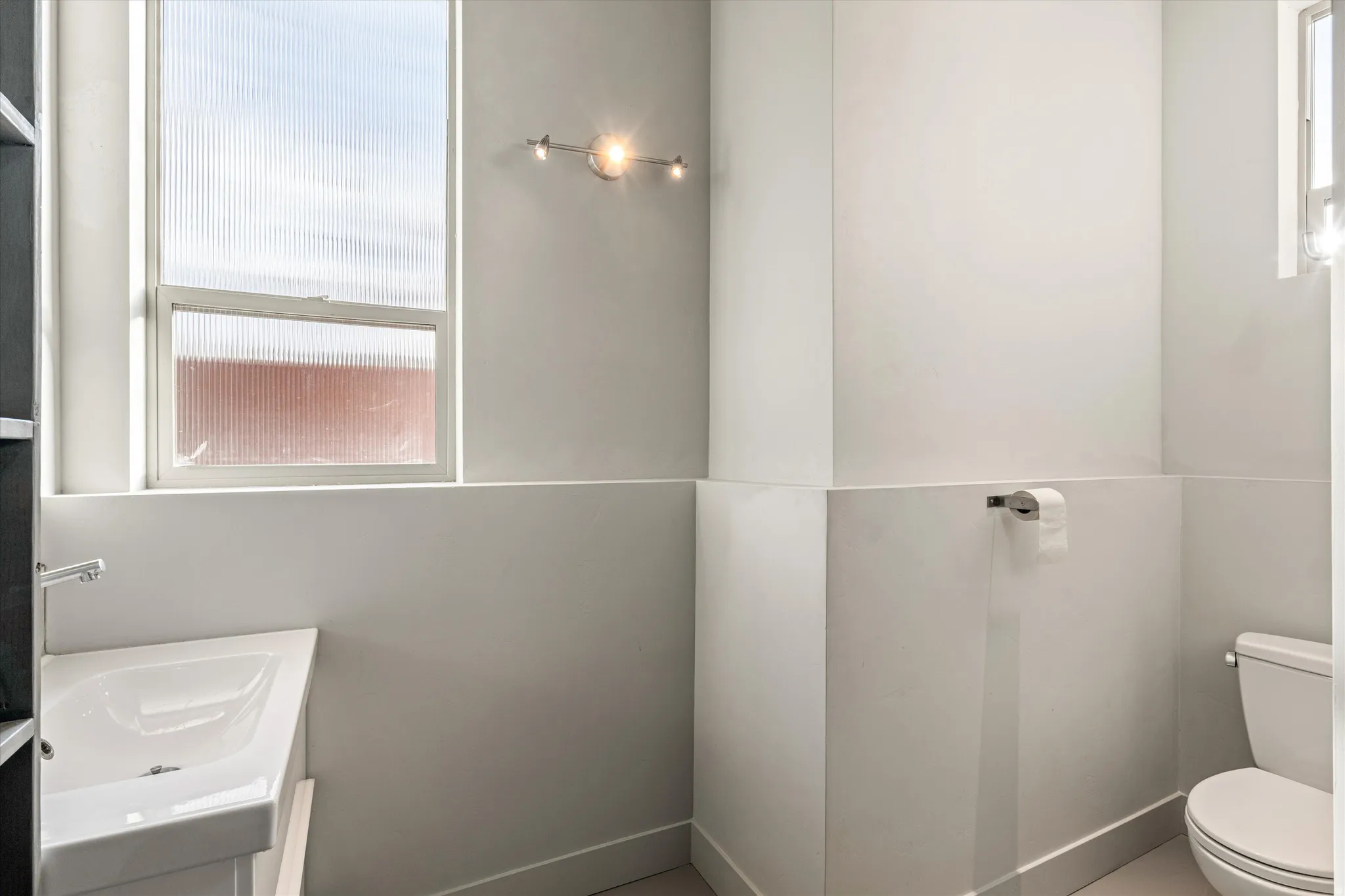 Half bathroom with toilet and vanity