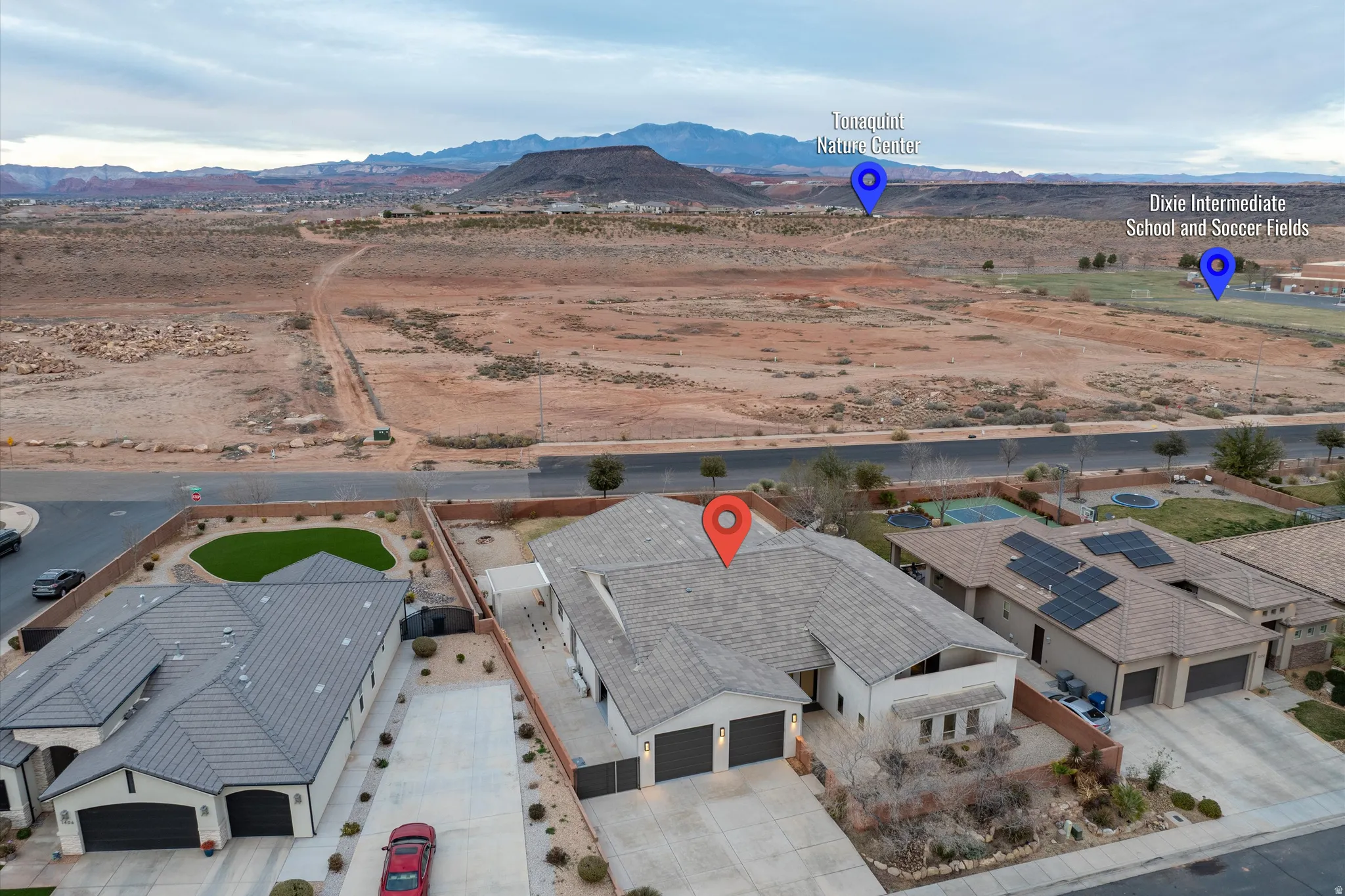 Aerial perspective of suburban area featuring a mountainous background