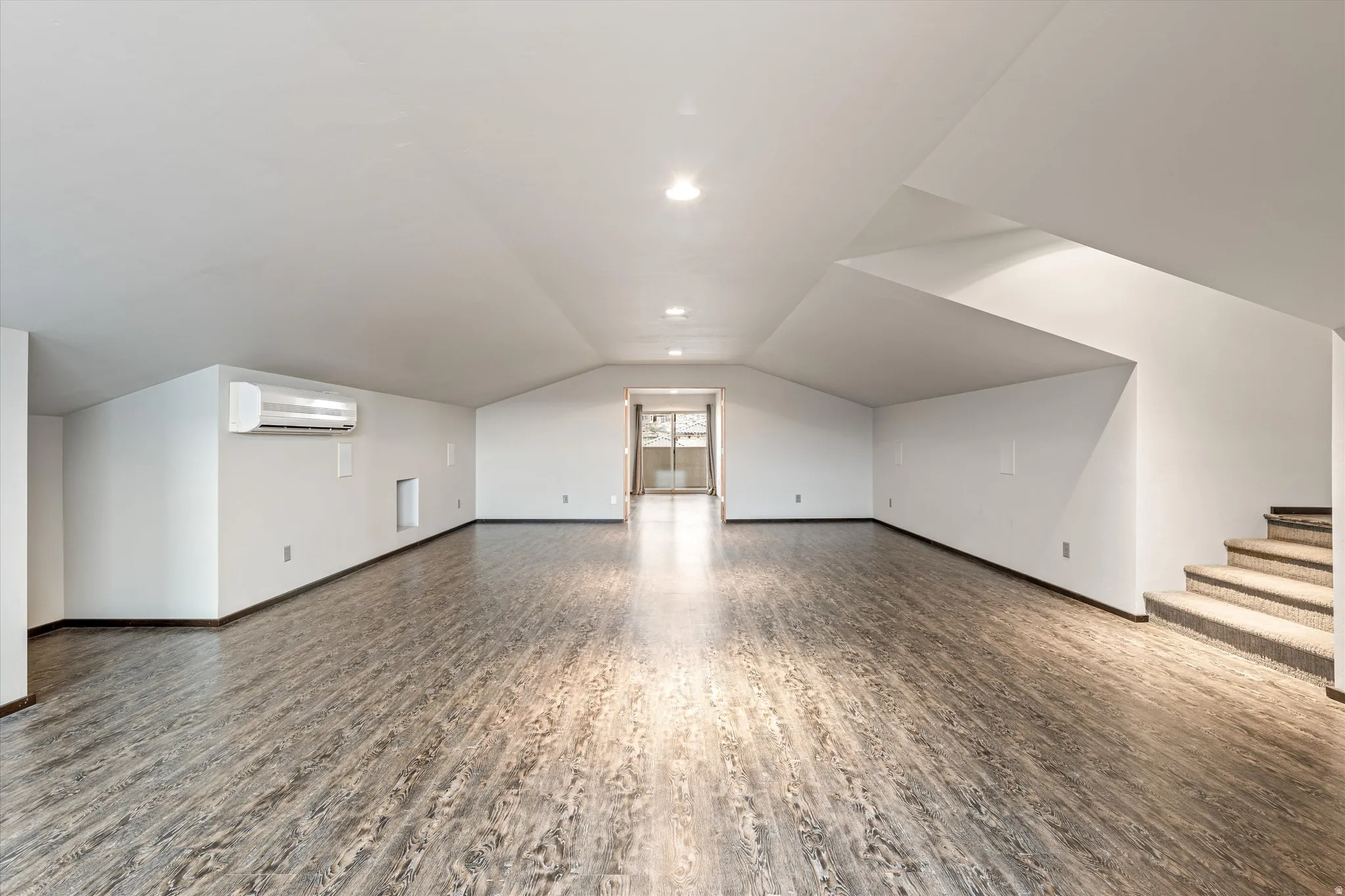 Bonus room featuring wood finished floors and baseboards