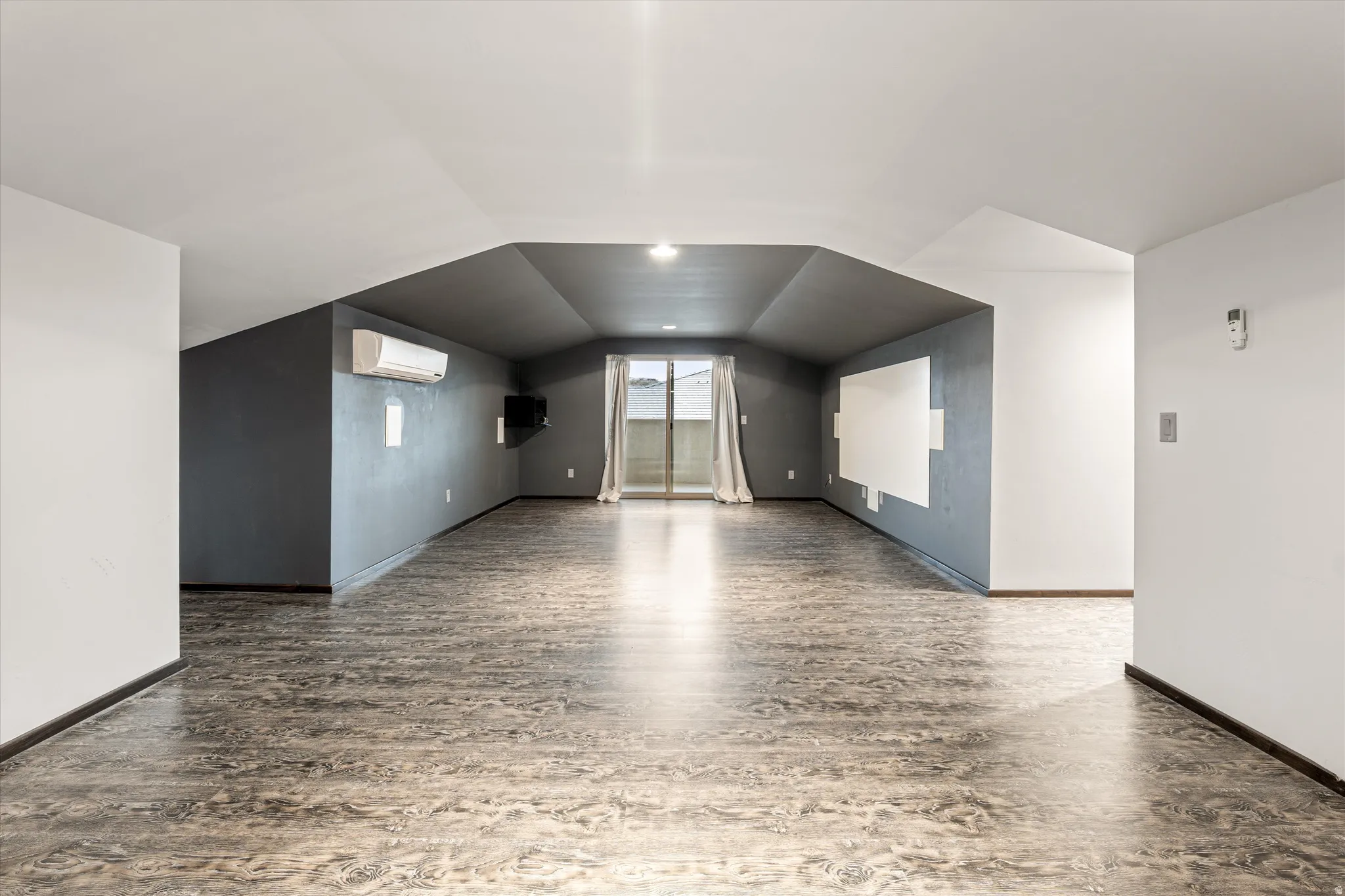 Additional living space with vaulted ceiling and wood finished floors