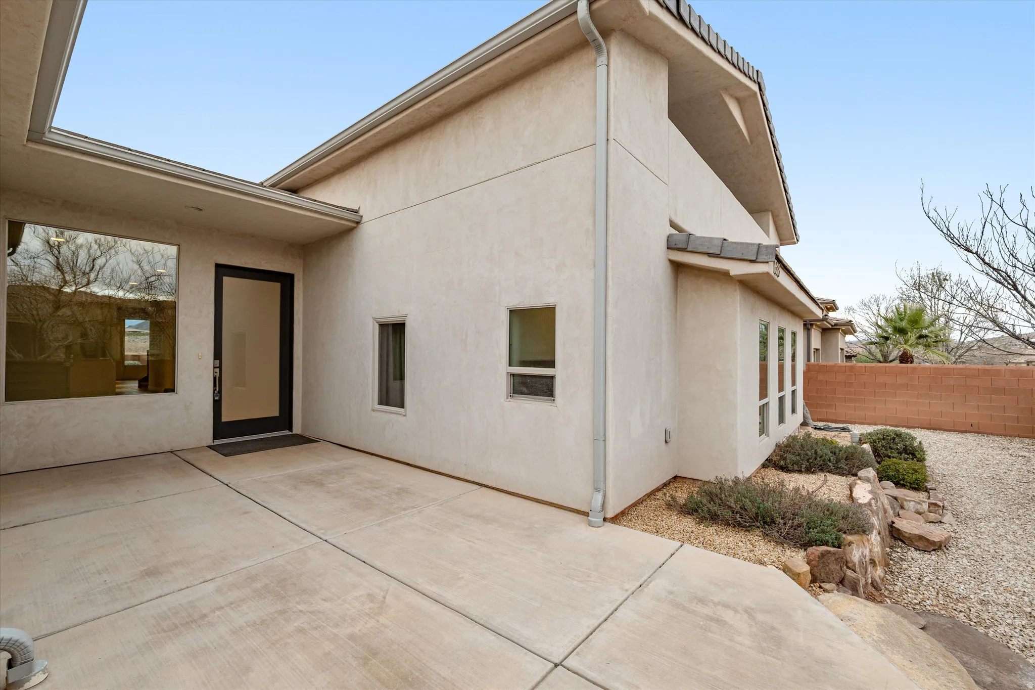 Rear view of property with stucco siding and a patio