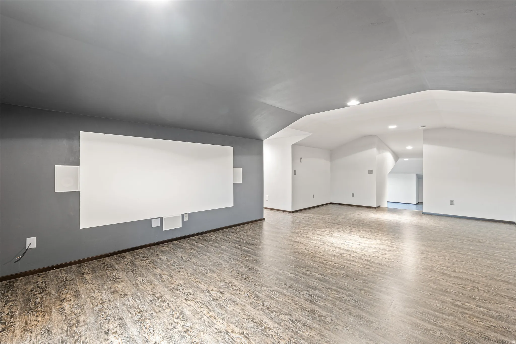 Bonus room with wood finished floors, lofted ceiling, and recessed lighting