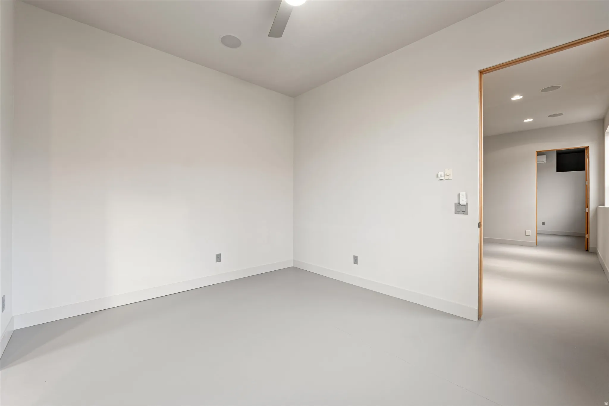 Spare room with concrete floors, recessed lighting, and a ceiling fan