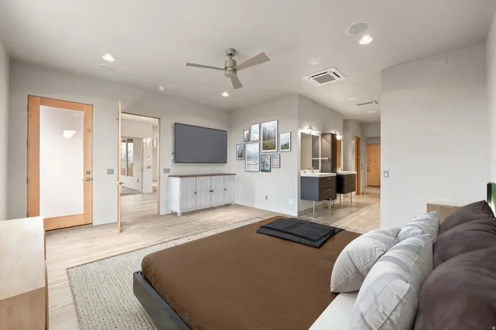 Bedroom with light wood-type flooring, cooling unit, recessed lighting, and ceiling fan