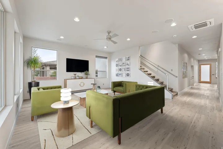Living room with wood finished floors, a ceiling fan, recessed lighting, and cooling unit