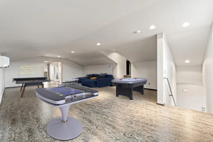 Game room with vaulted ceiling and recessed lighting