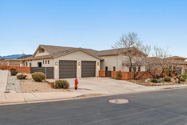 Ranch-style home with driveway, stucco siding, and an attached garage