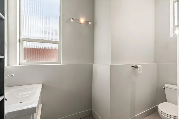 Half bathroom with toilet and vanity