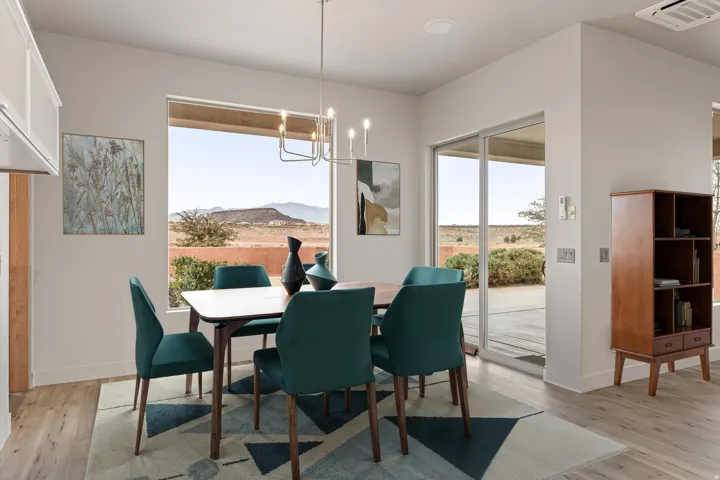 Dining room with a mountain view, light wood-style flooring, and hanging lights