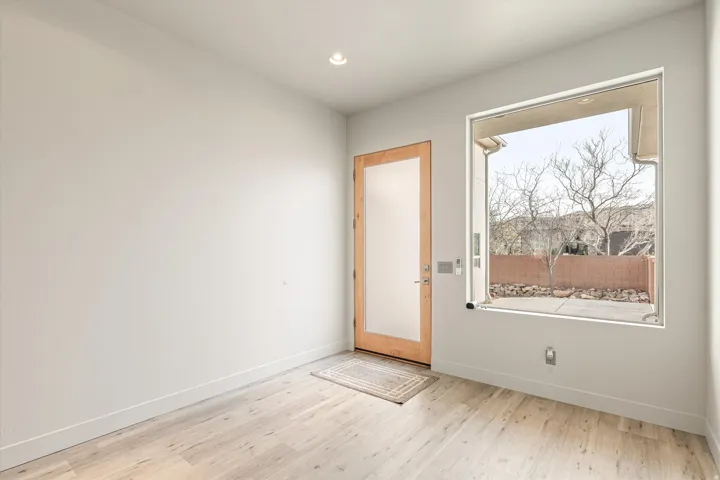 Doorway featuring wood finished floors and recessed lighting