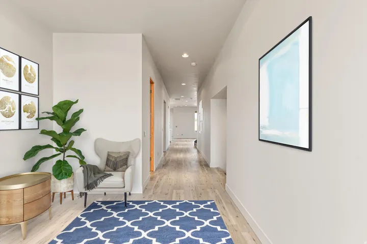 Corridor with light wood-style floors and recessed lighting