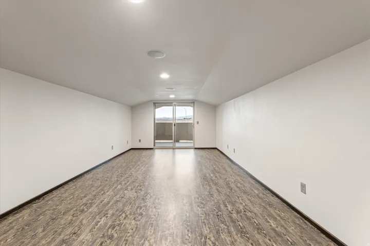 Bonus room featuring vaulted ceiling and wood finished floors