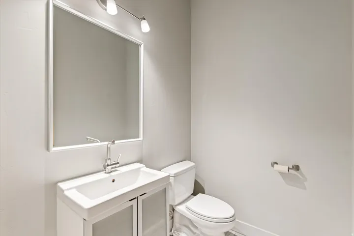Half bathroom with vanity and toilet