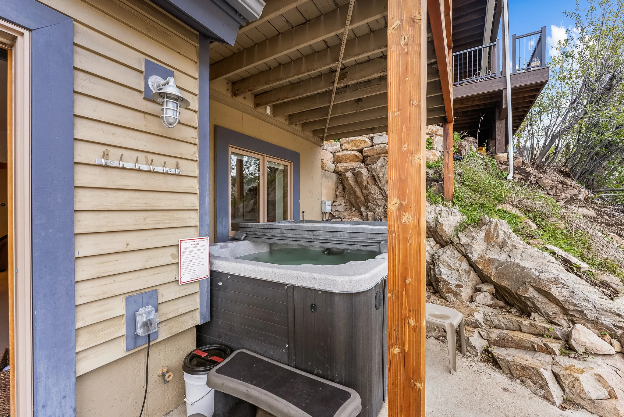 Exterior view of stone siding and a jacuzzi