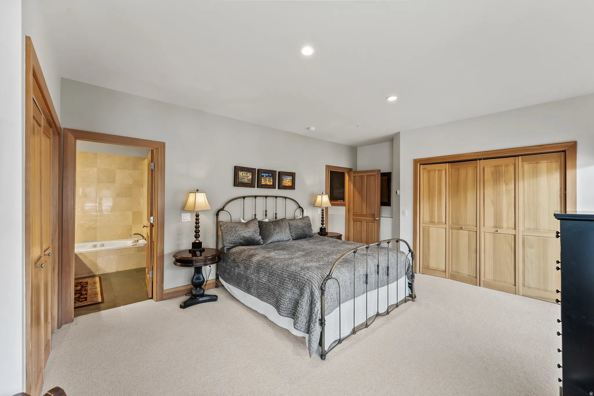 Bedroom featuring a closet, carpet flooring, recessed lighting, and ensuite bathroom