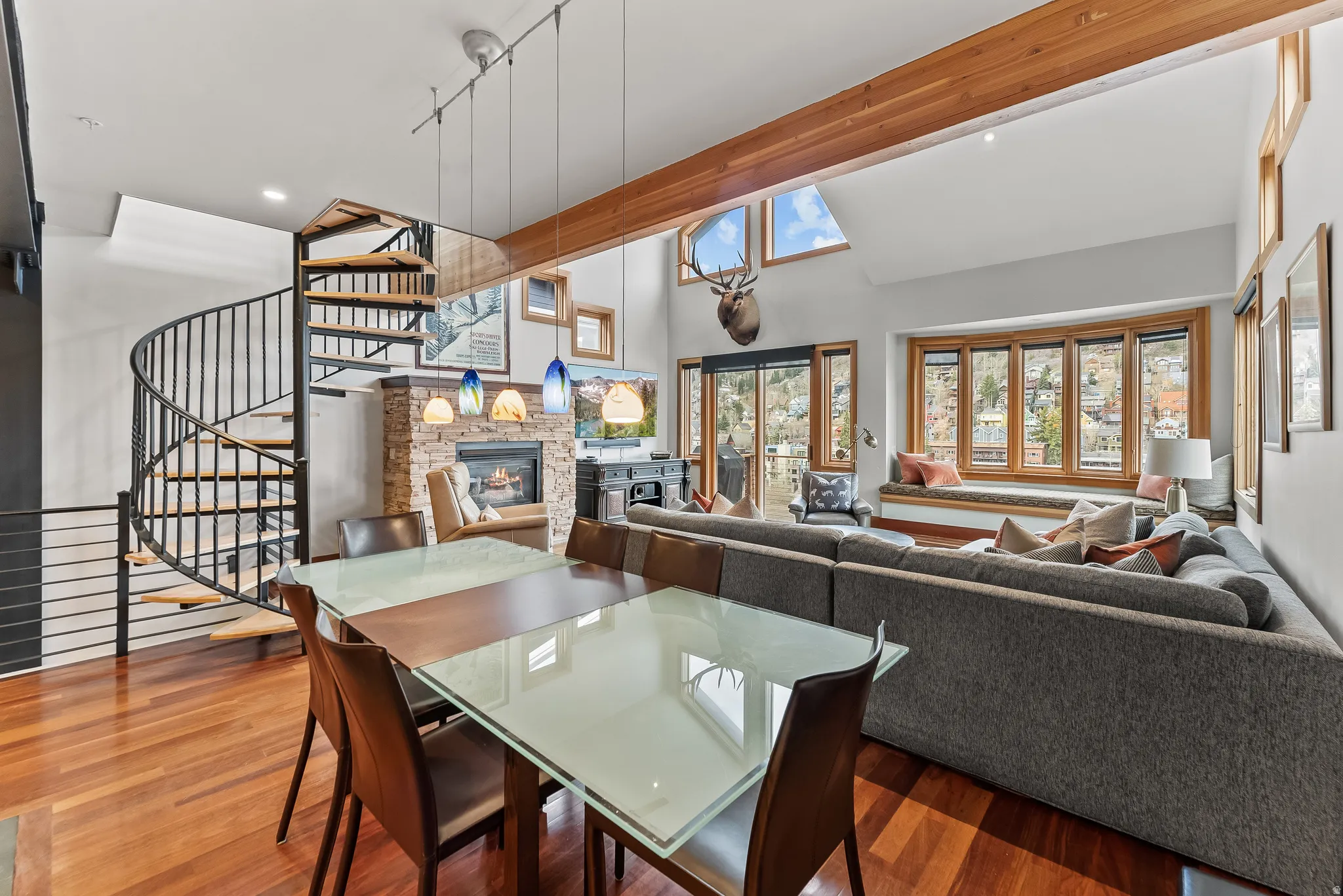 Dining area with a fireplace, wood finished floors, and recessed lighting