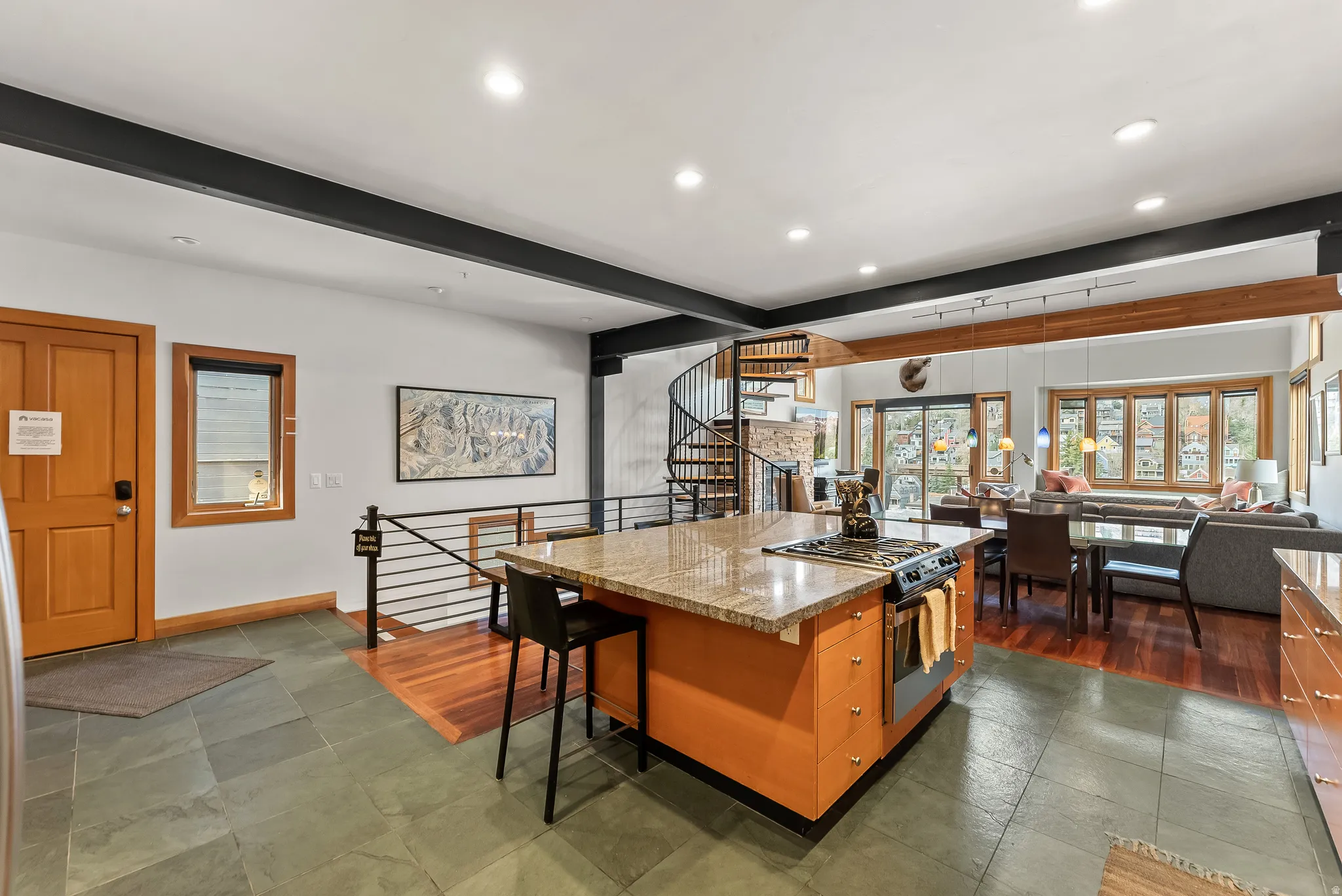 Kitchen featuring recessed lighting, gas stove, a kitchen island, beam ceiling, and wood finish cabinets