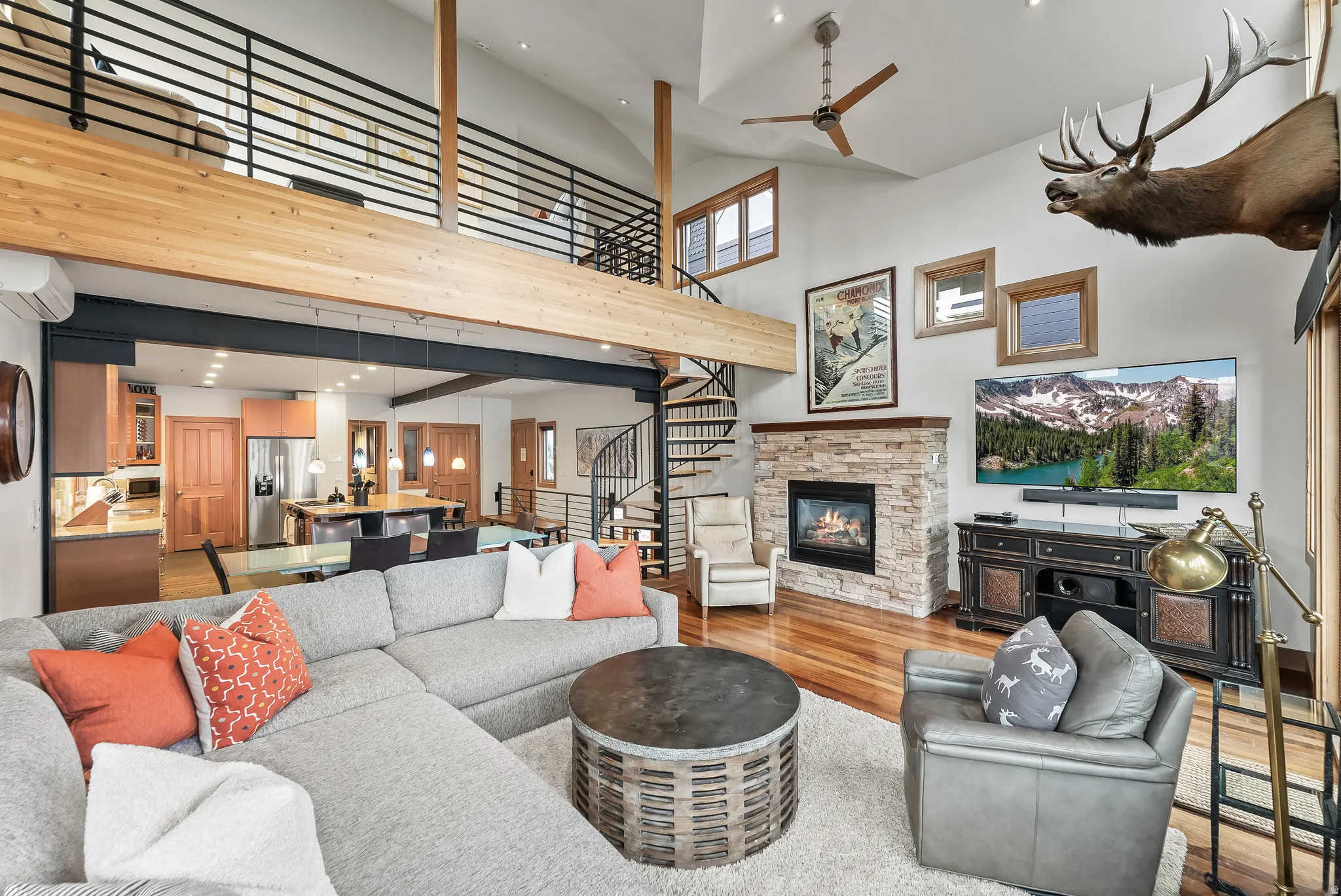 Living room with recessed lighting, light wood finished floors, a stone fireplace, vaulted ceiling, and ceiling fan