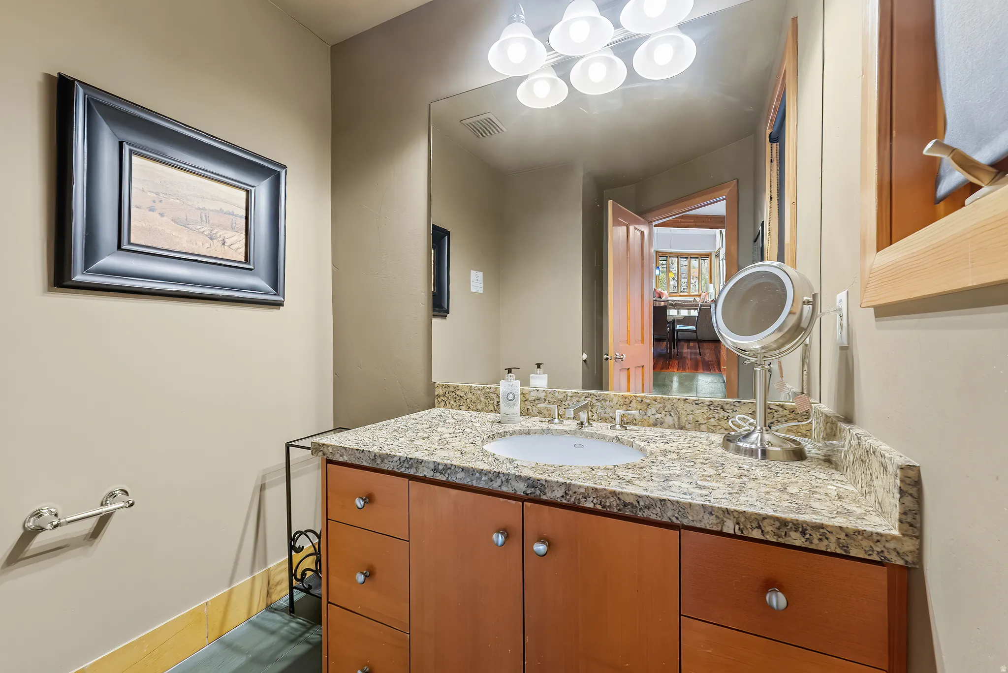 Half bath featuring vanity and baseboards
