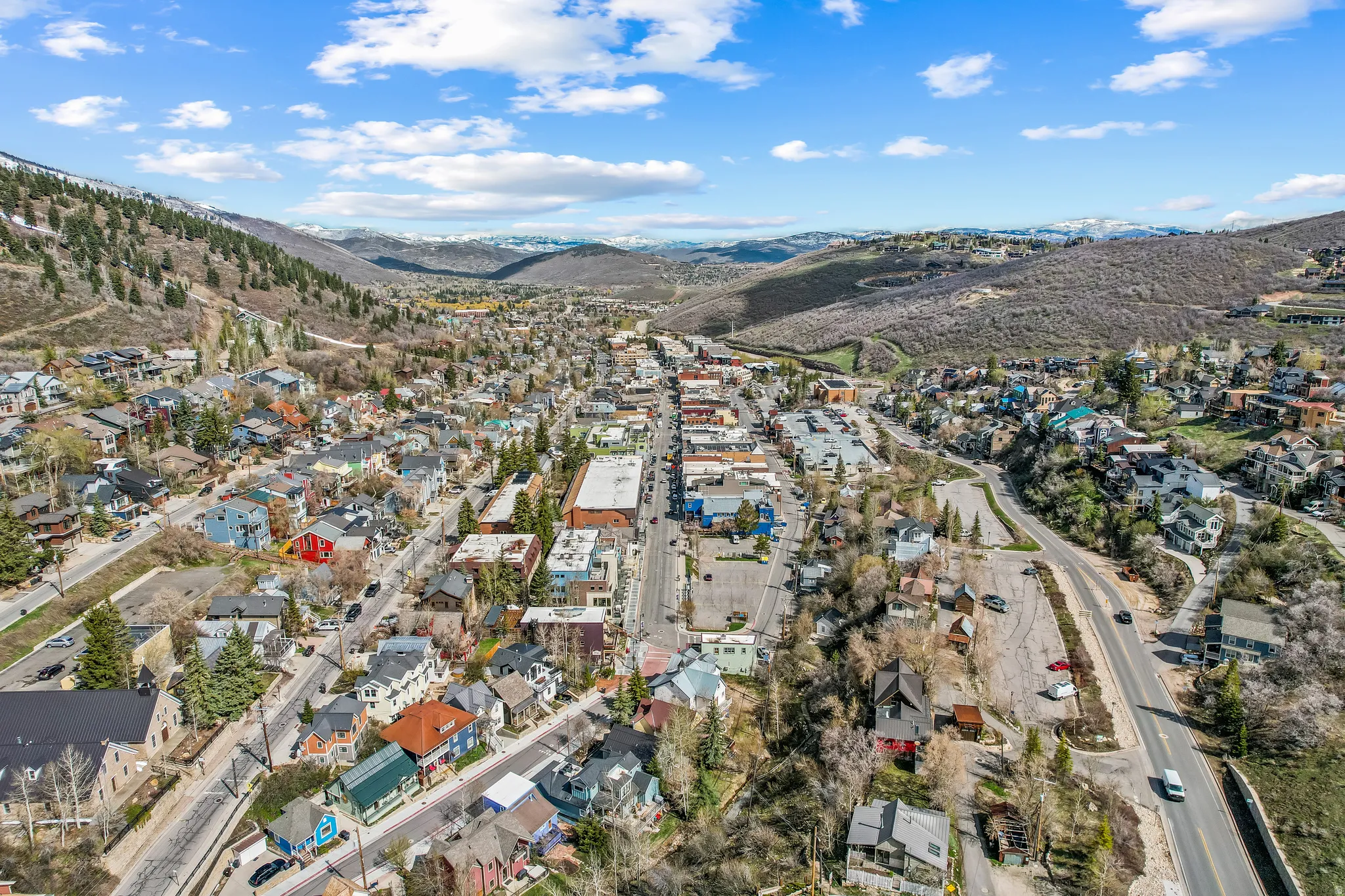Aerial overview of property's location with a mountain backdrop and nearby suburban area