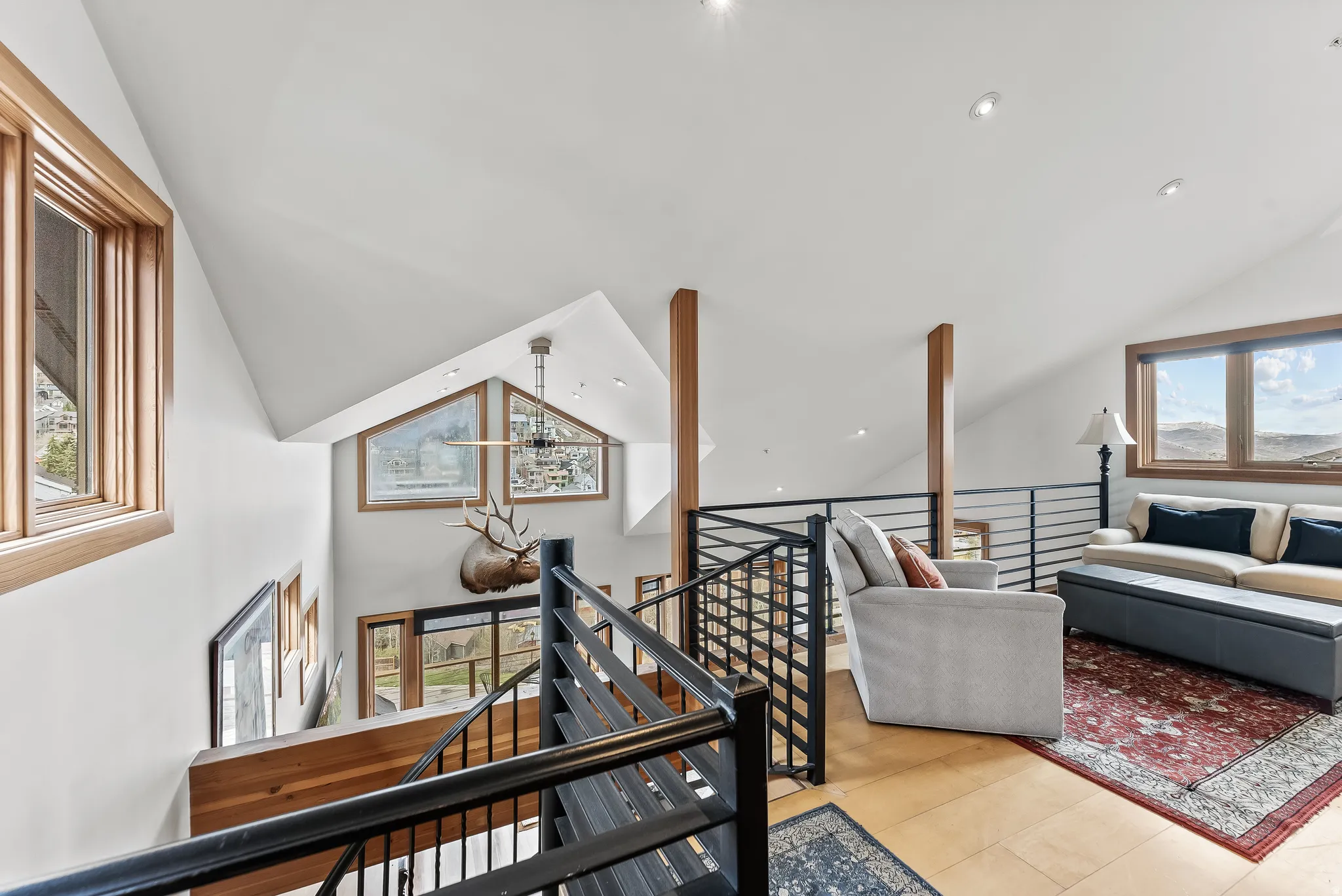 Staircase featuring plenty of natural light, wood finished floors, and a high ceiling