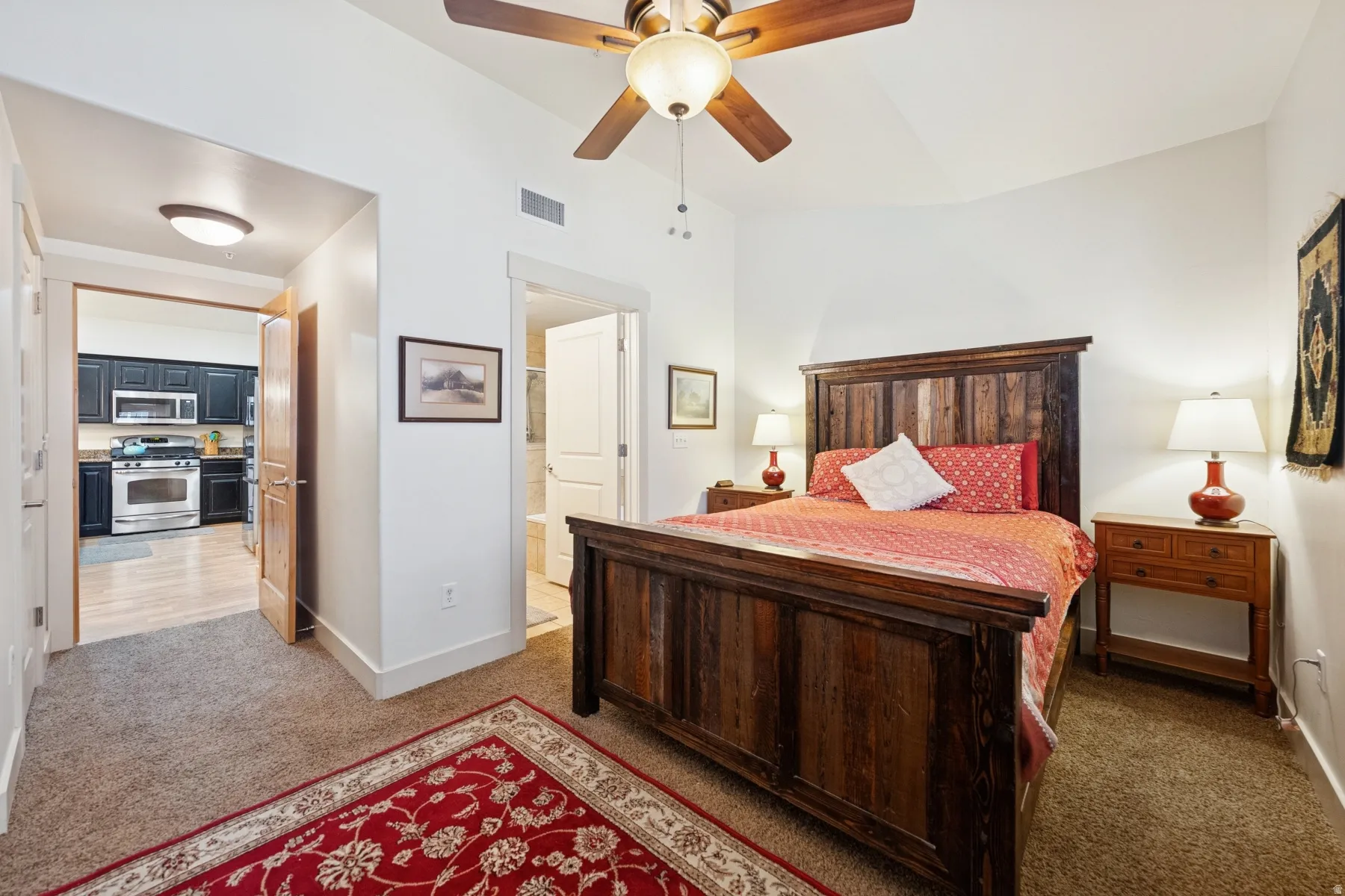 Bedroom with light carpet and a ceiling fan