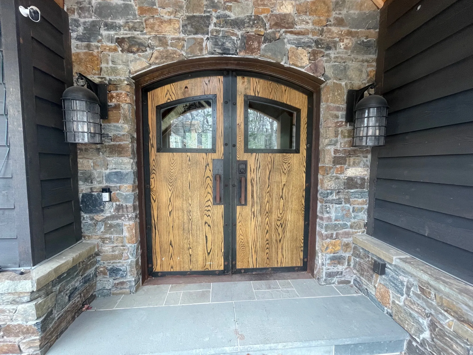Entrance to property with stone siding