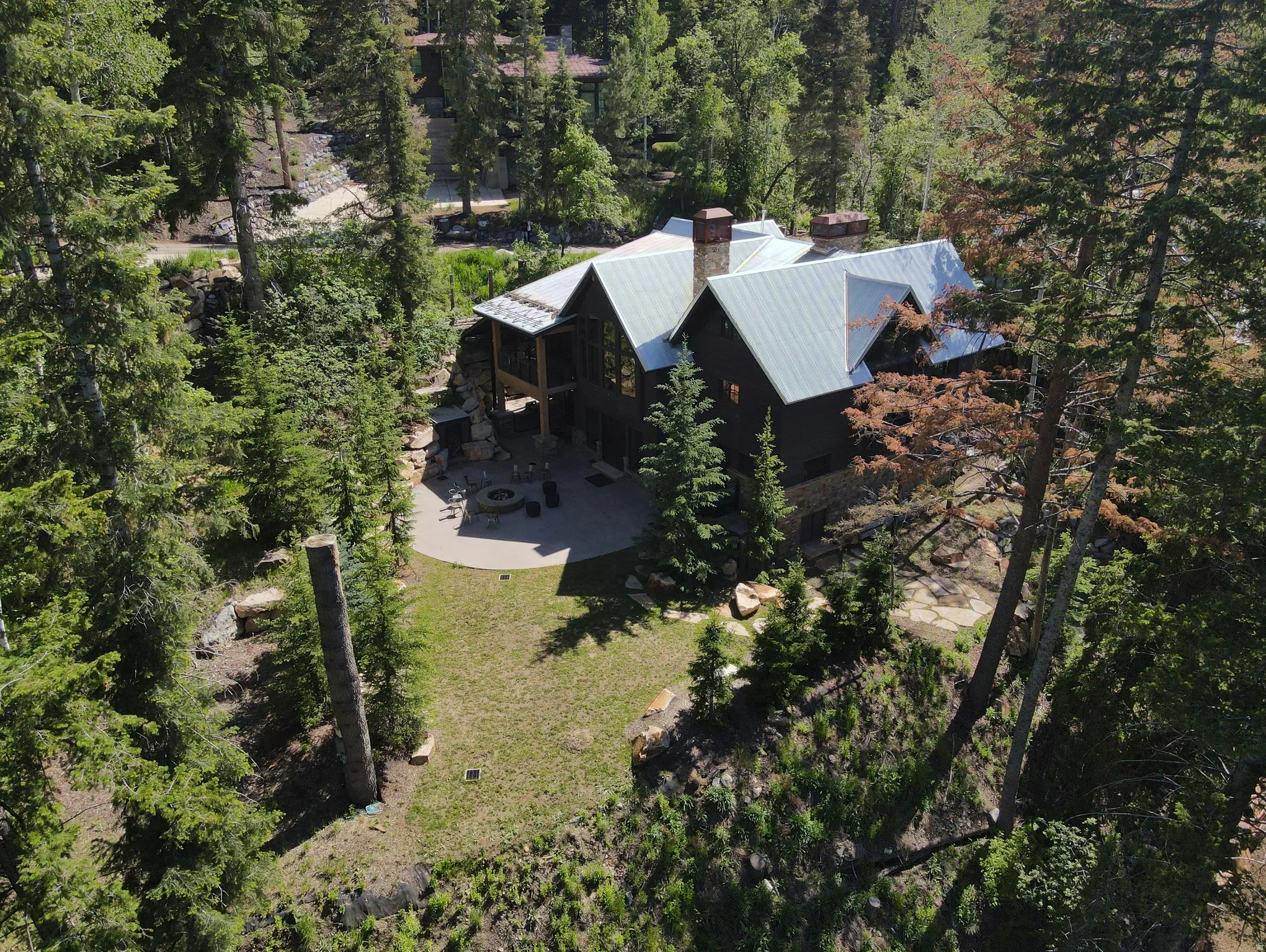 Mountain retreat featuring a large dwelling with multiple gables and a metal roof
