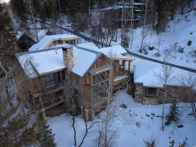 View of snowy exterior featuring a chimney