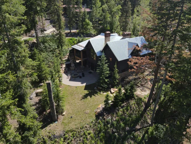 Mountain retreat featuring a large dwelling with multiple gables and a metal roof
