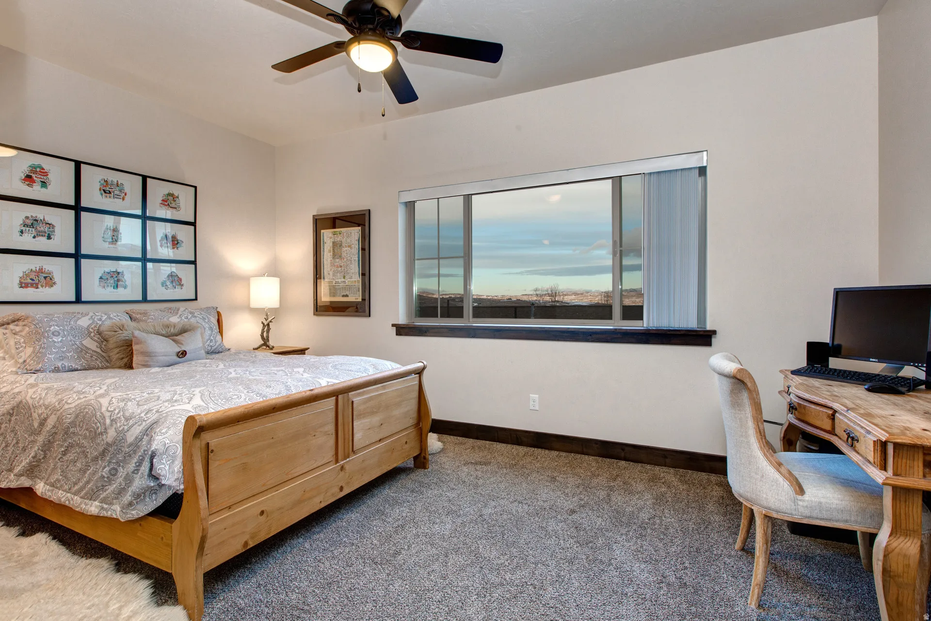 Carpeted bedroom with ceiling fan and a desk