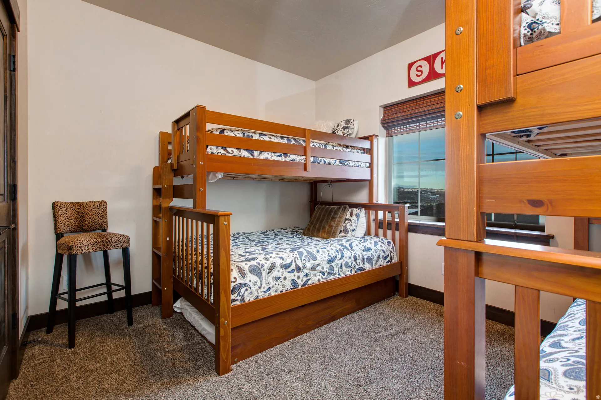 Bedroom featuring baseboards and carpet