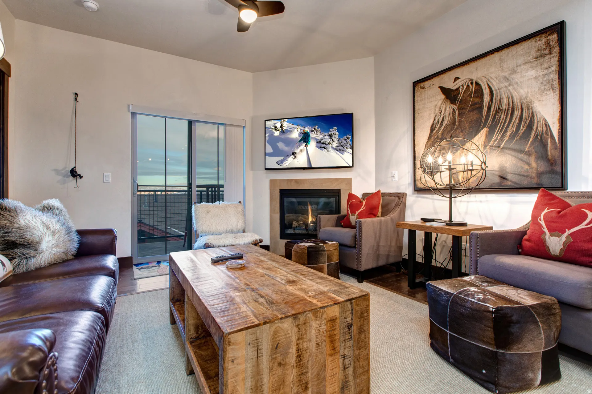 Living area featuring a fireplace, wood finished floors, and a ceiling fan