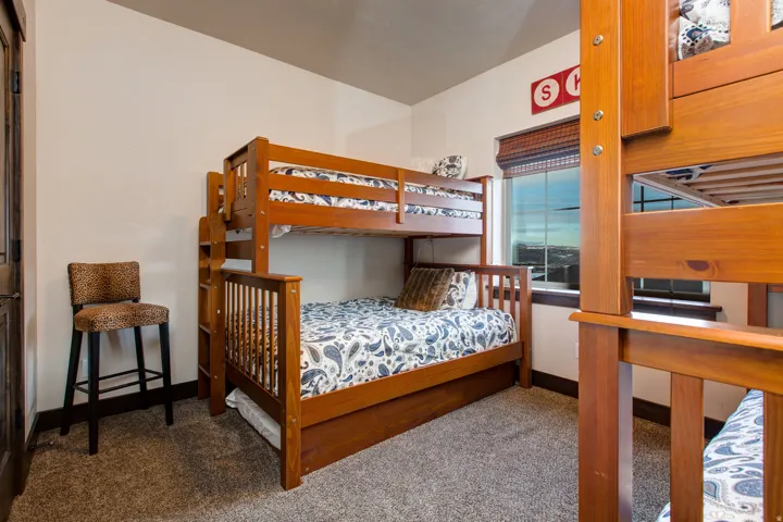 Bedroom featuring baseboards and carpet