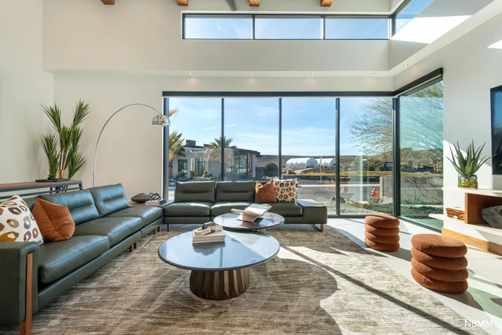 Living area with a high statement windows and ceiling