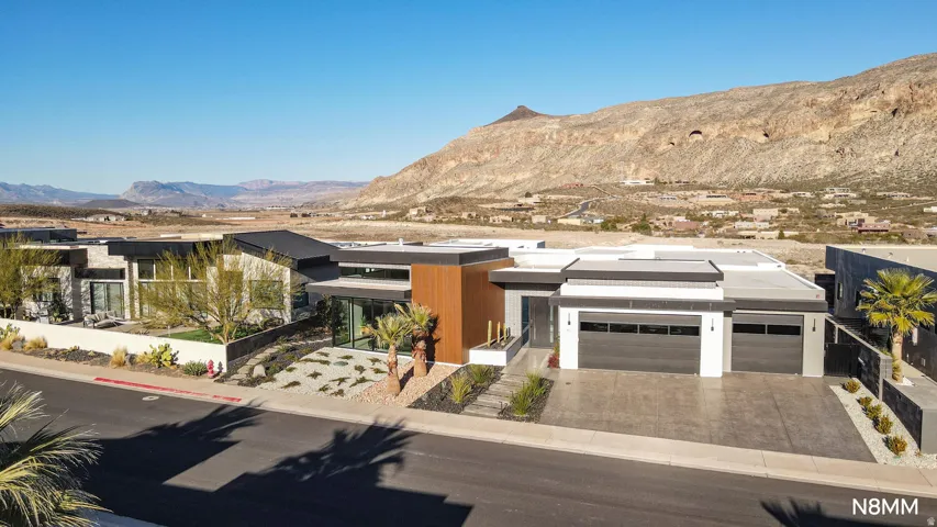 View of front facade with a mountain view, driveway, and an attached garage