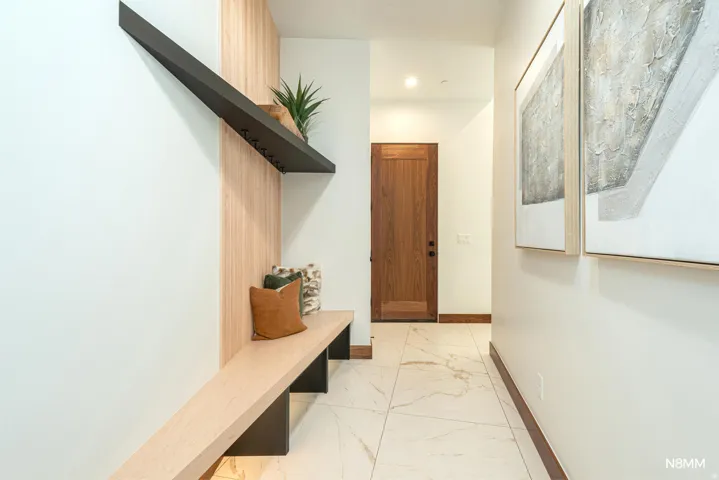 Mudroom area with light finish flooring and recessed lighting