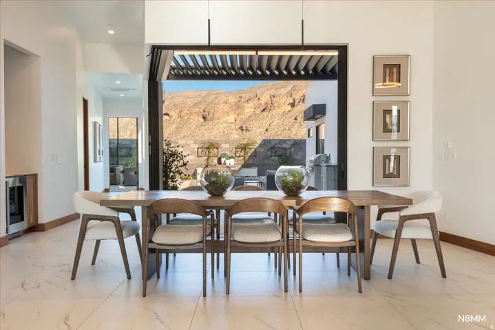 Dining room with a mountain view and entrance out to the pool.