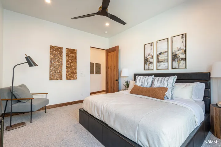 Carpeted bedroom featuring ceiling fan and recessed lighting