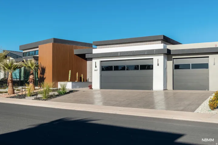 Modern home featuring an attached garage and concrete driveway