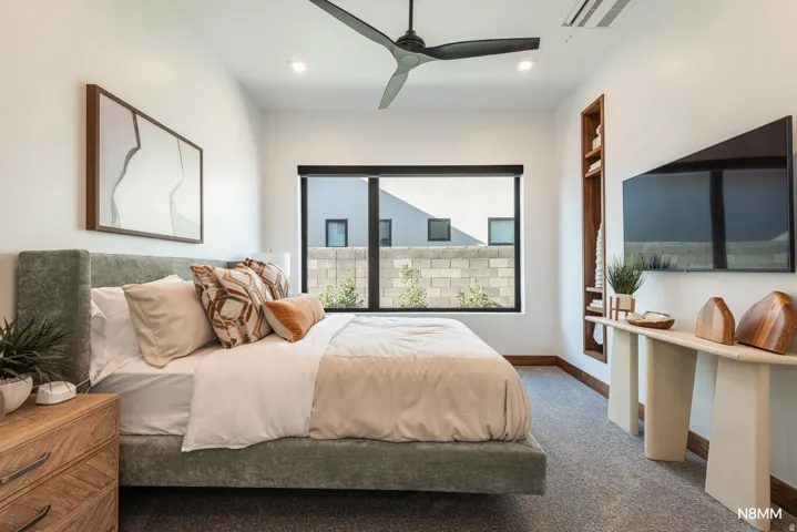 Bedroom with carpet and ceiling fan
