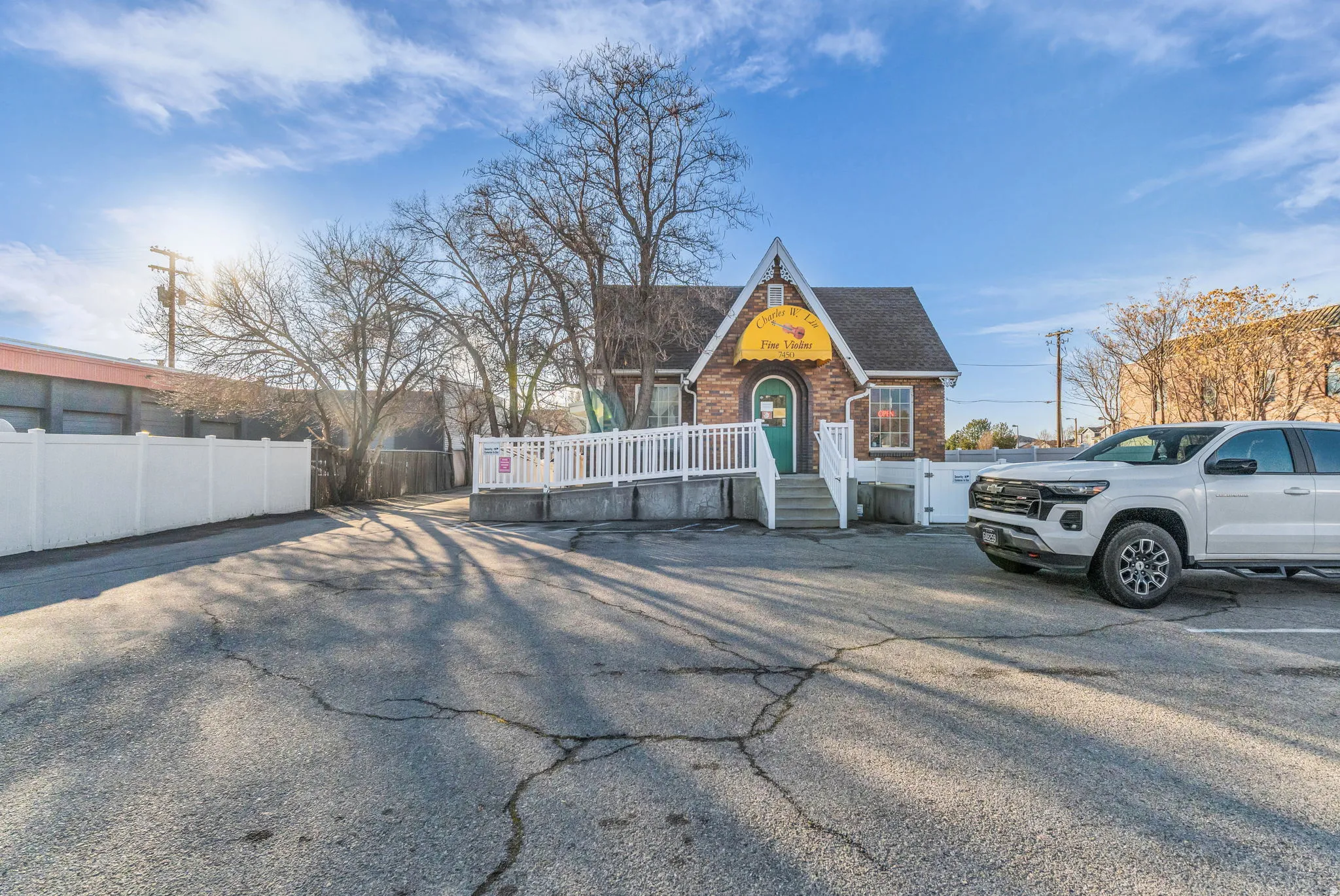 View of front facade featuring brick siding and a shingled roof