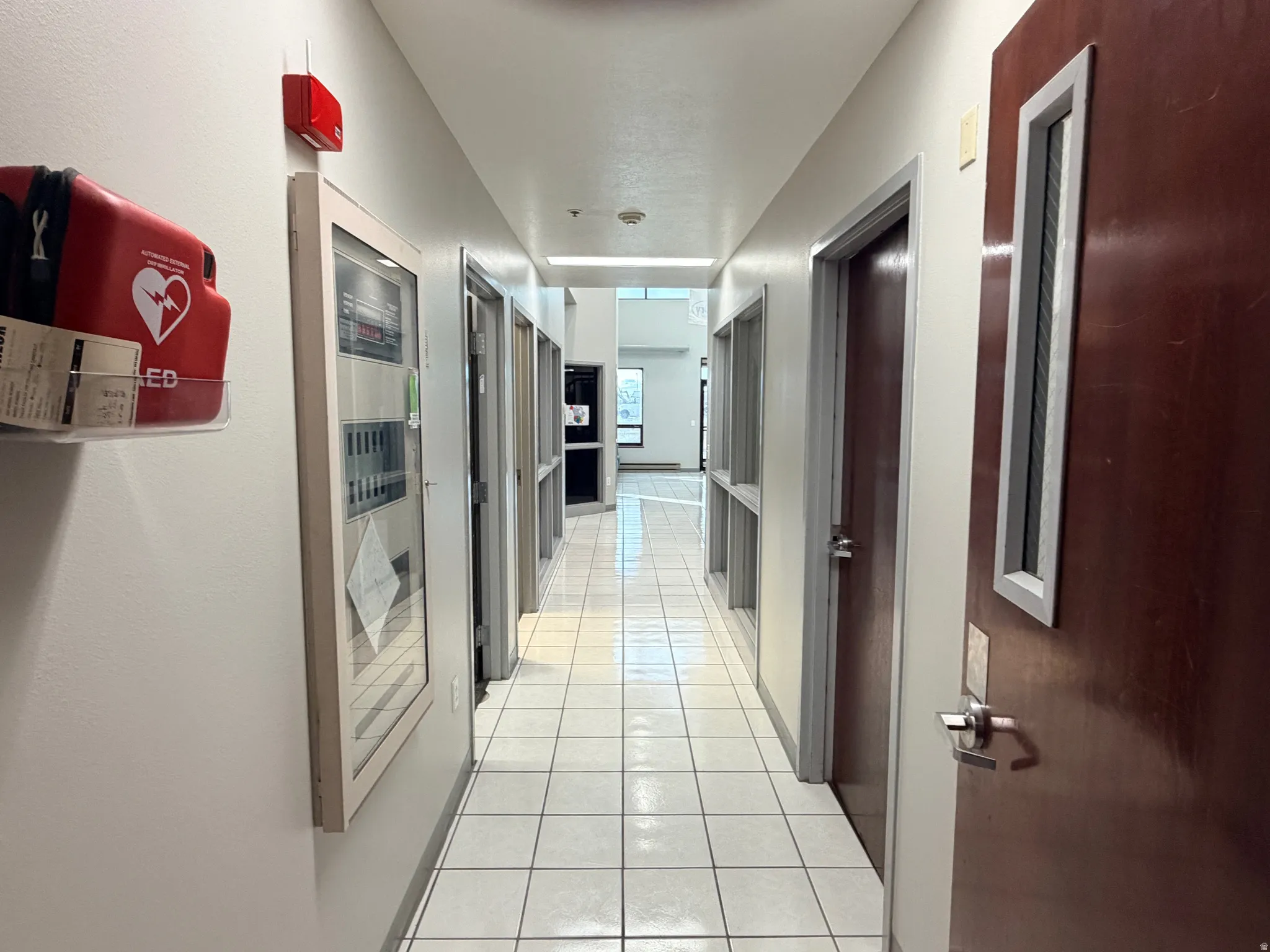 Corridor featuring light tile patterned floors