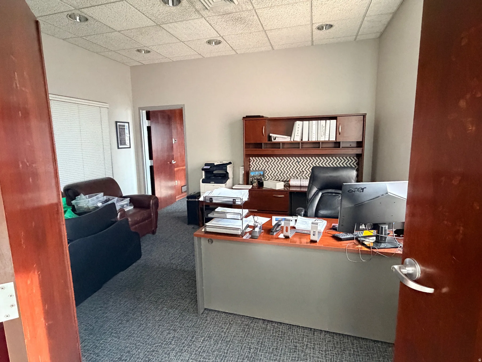 Office area featuring a paneled ceiling