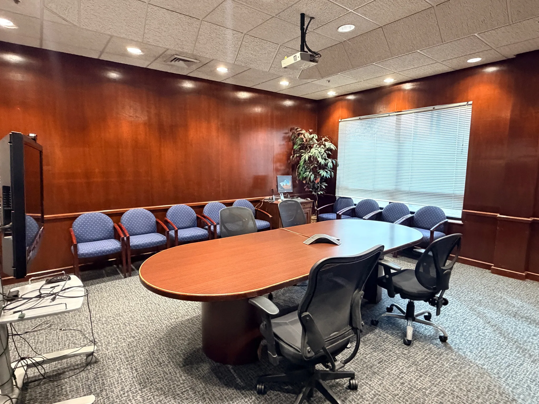 Conference room featuring wooden walls, a paneled ceiling, and recessed lighting