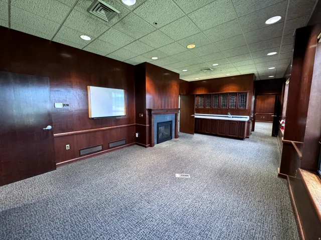 CEO Office w fireplace and cherry wood paneling