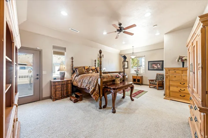 Bedroom with light carpet, ceiling fan, access to exterior, and recessed lighting